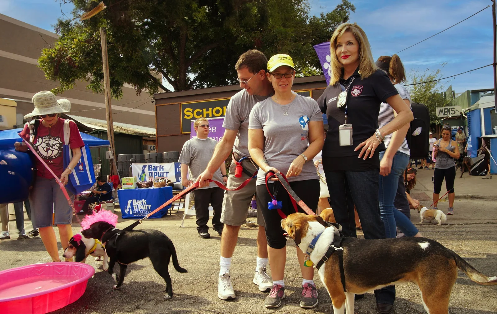 Marie Betcher in her police chaplain shirt at an outdoor community event with dogs